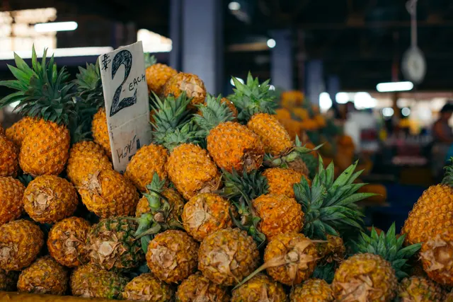 Pineapples piled high on a stall at the market in Suva